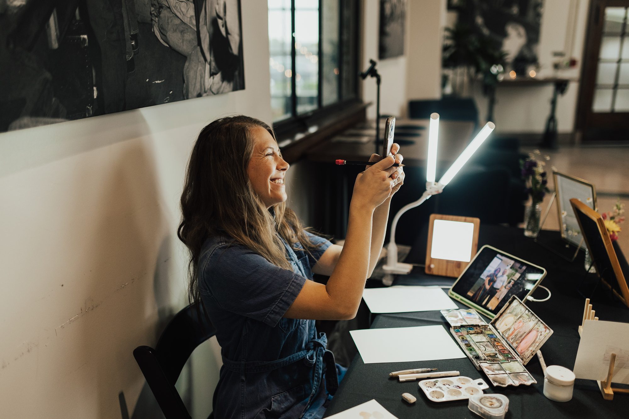Nicole Raphael at her live painting table during an event